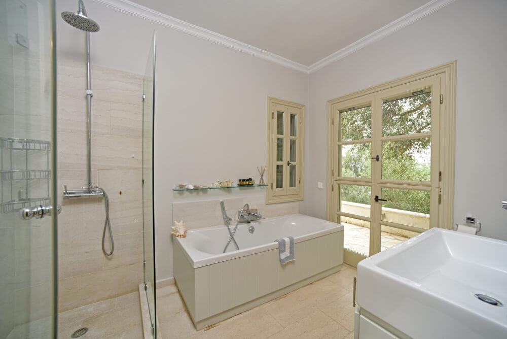 Bright en-suite bathroom at Villa Eremia with garden view and walk-in shower