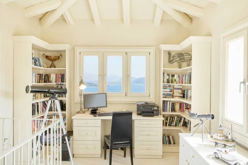 Playroom at Villa Eremia with floor-to-ceiling windows and panoramic Corfu sea views