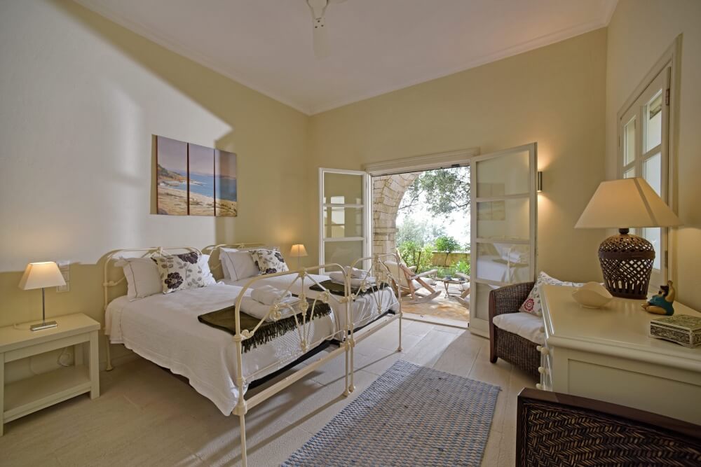 Master bedroom suite at Villa Eremia with private terrace access and sea views, Corfu