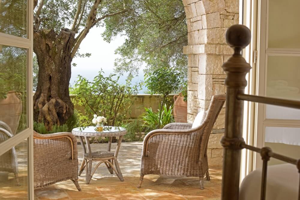 Outdoor terrace at Villa Eremia framed by stone columns with panoramic Ionian Sea views