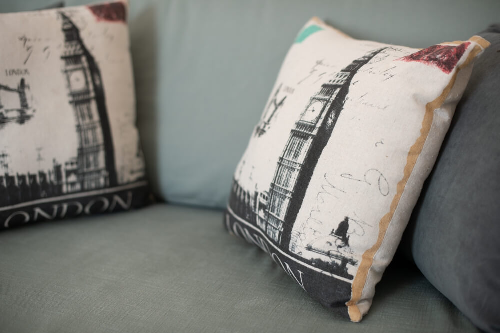 Close-up of stylish bedding and accent cushion in an Elyonas Cottage bedroom, Corfu
