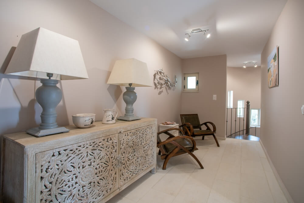 Living area console at Elyonas Cottage with twin table lamps and traditional Corfiot styling
