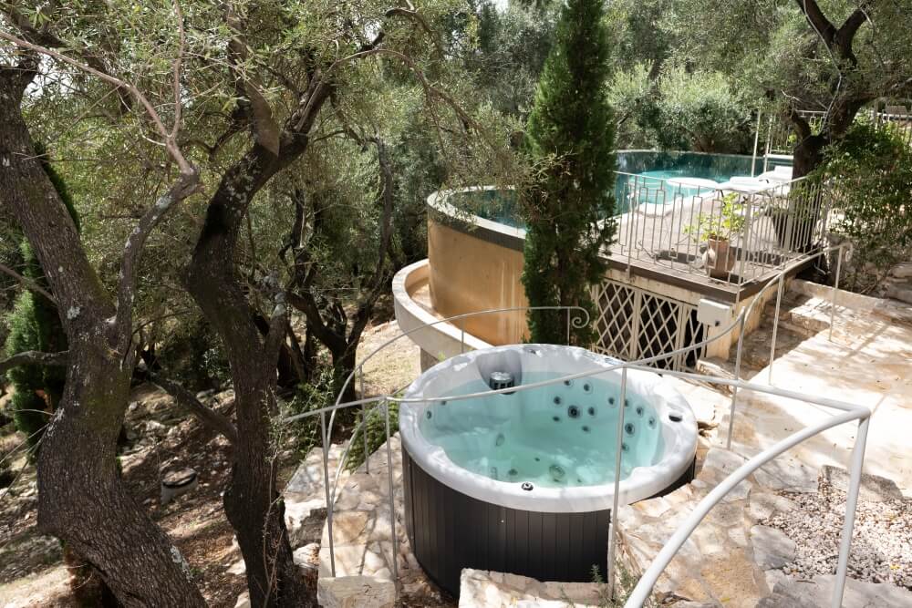 Outdoor jacuzzi at Elyonas Cottage nestled among centuries-old olive trees, Eremia Estate Corfu