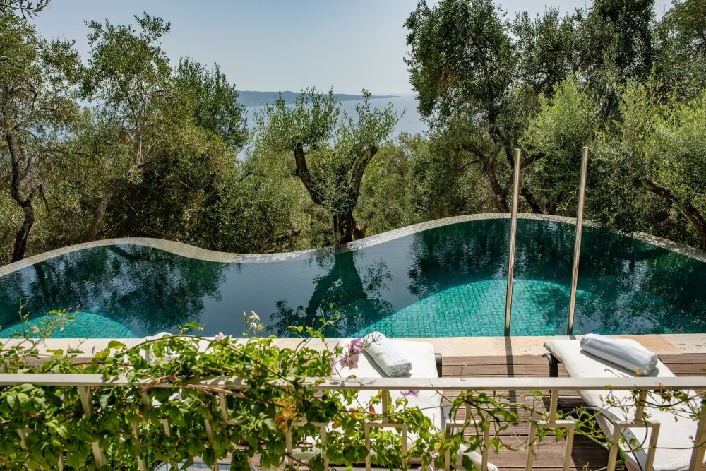 Private pool at Elyonas Cottage with Indonesian-style tiles framed by olive trees and Ionian Sea views
