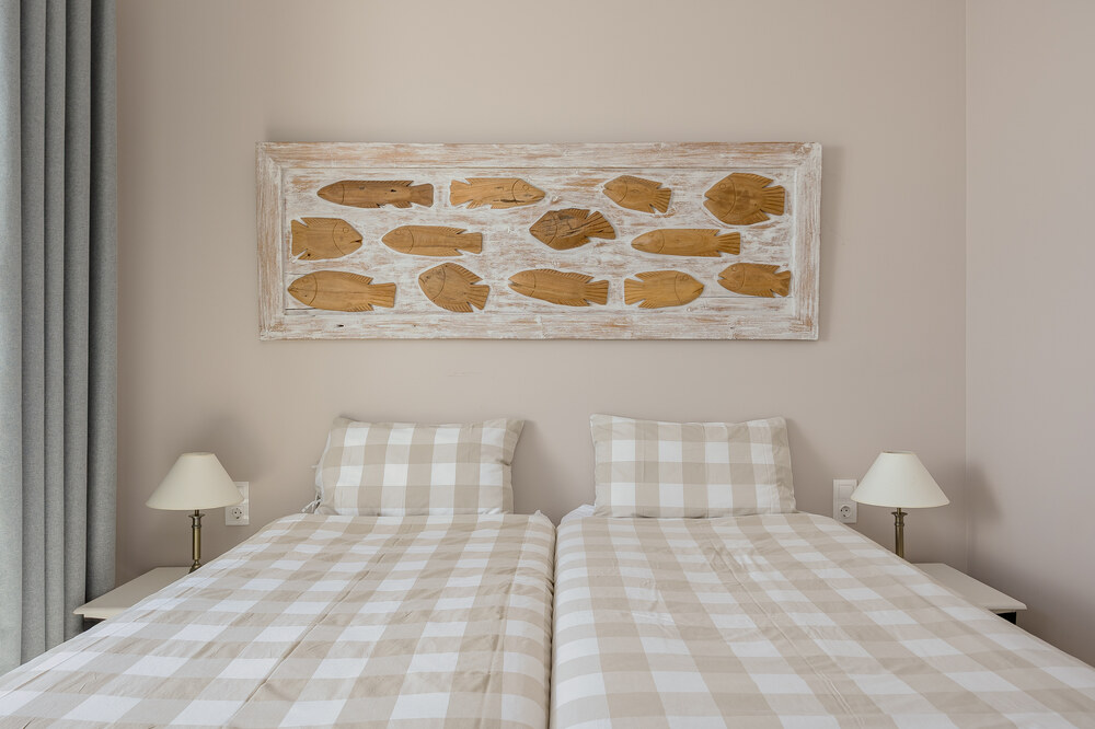 Twin bedroom at Elyonas Cottage with two single beds and matching gingham linens, Corfu