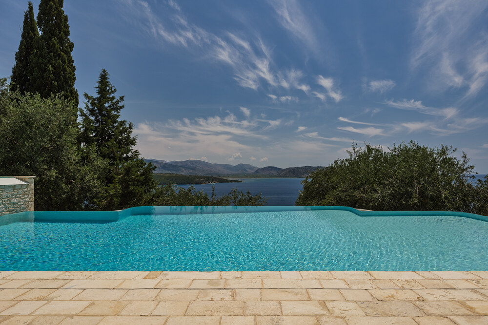 Turquoise infinity pool with panoramic sea and mountain view at Villa Eremia, Corfu